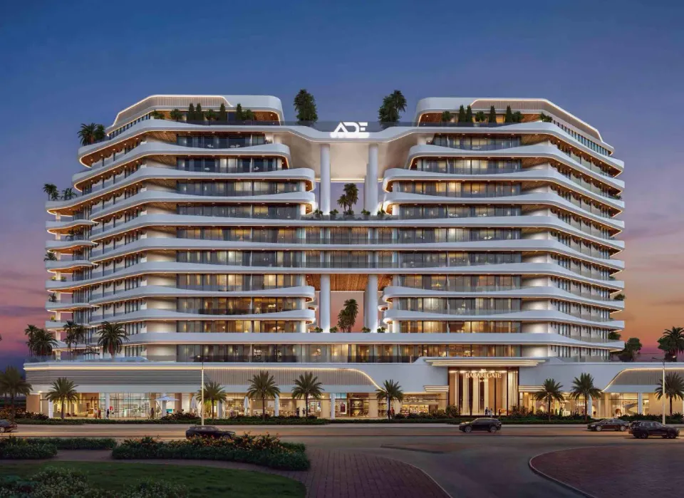 Barari Gate front elevation with illuminated curved balconies at dusk by ADE Properties