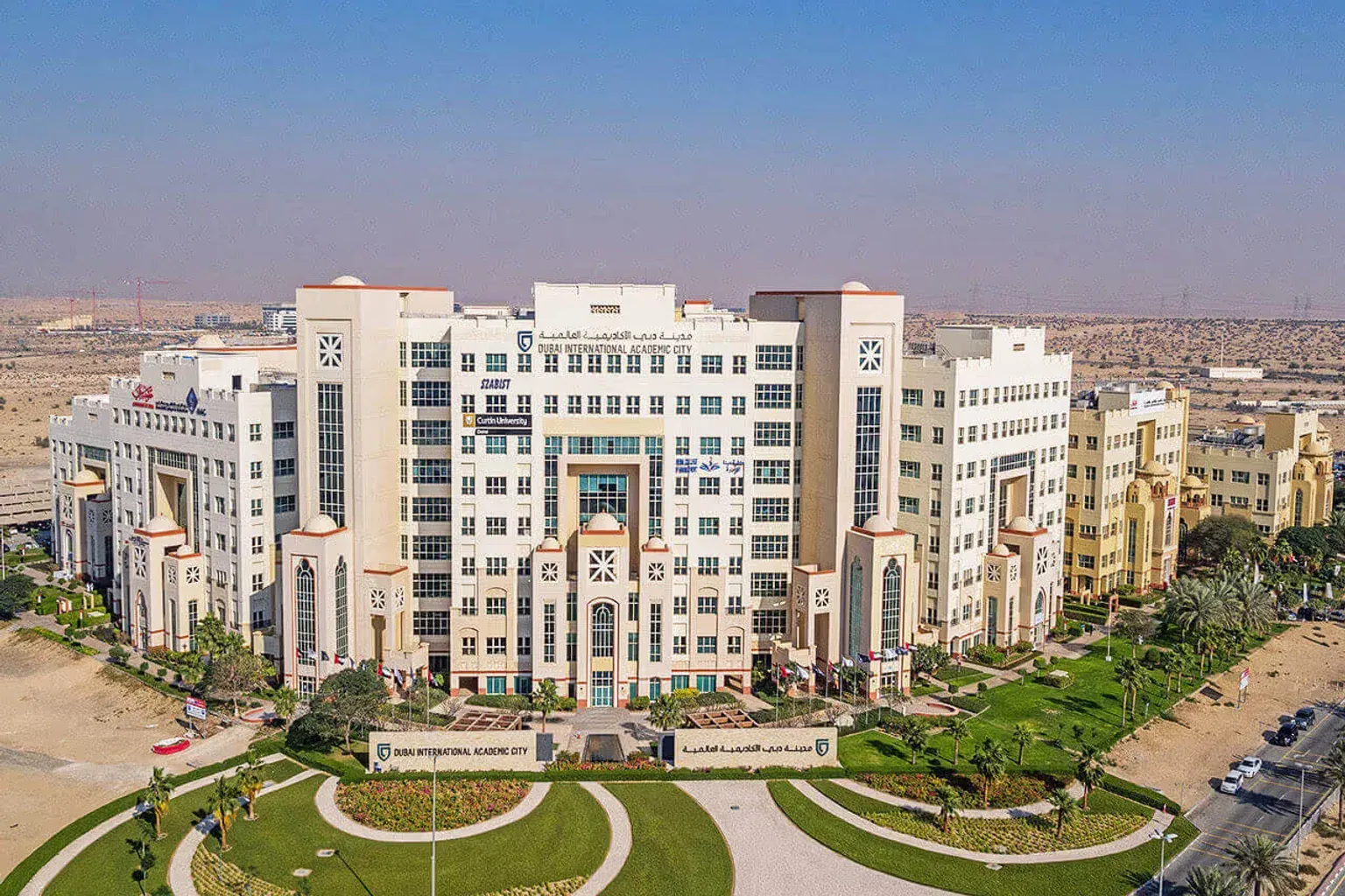 Aerial view of university buildings and landscaped campuses in Dubai International Academic City