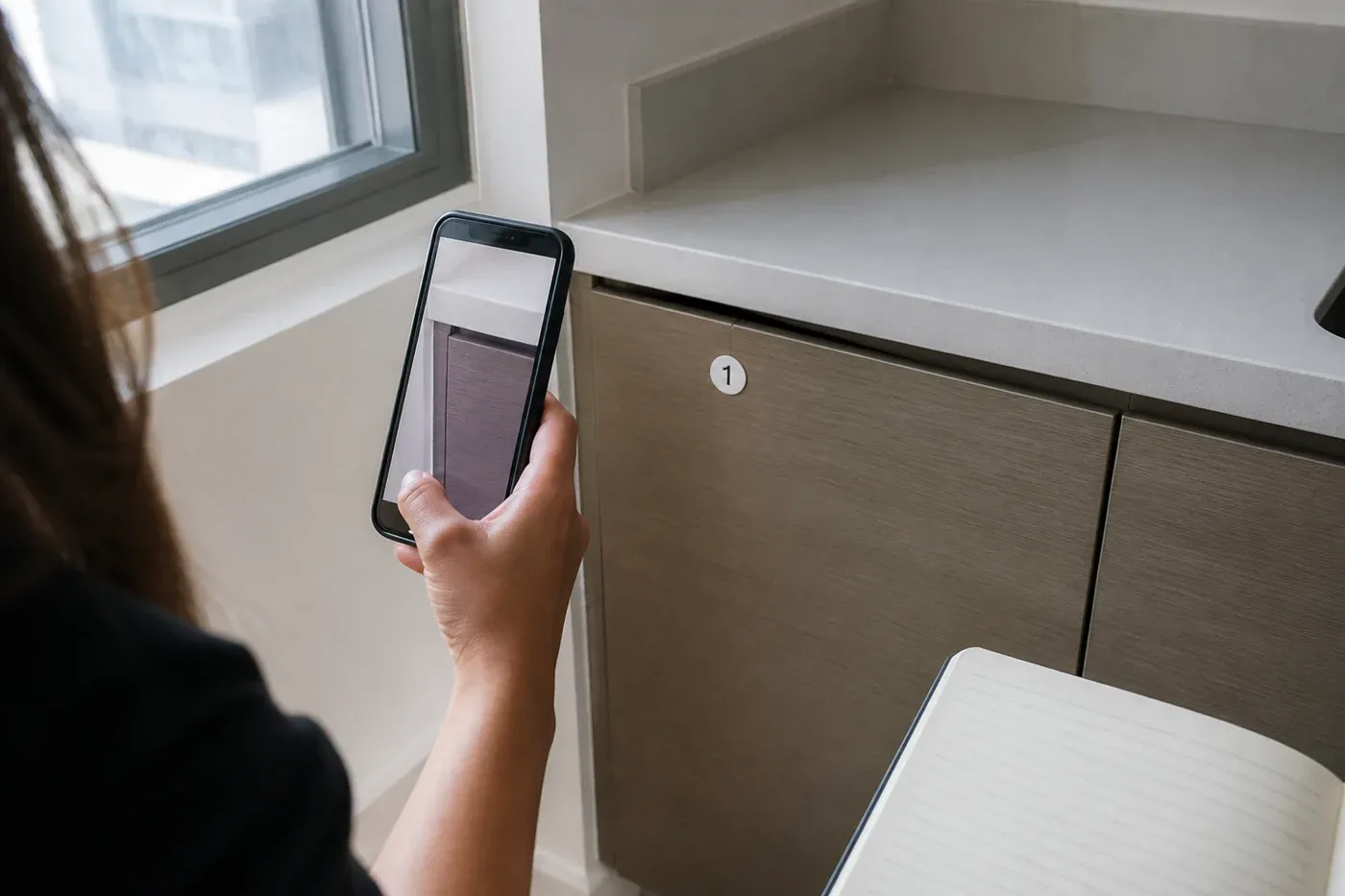 Buyer photographing a misaligned kitchen cabinet during a UAE off-plan property handover inspection