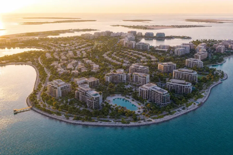 Aerial view of a low-rise Abu Dhabi island residential masterplan at golden hour