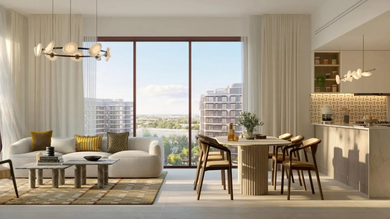 Open-plan living room, dining area and kitchen in The Canopies at Yas Point, finished in pale stone, light timber and warm neutral tones.