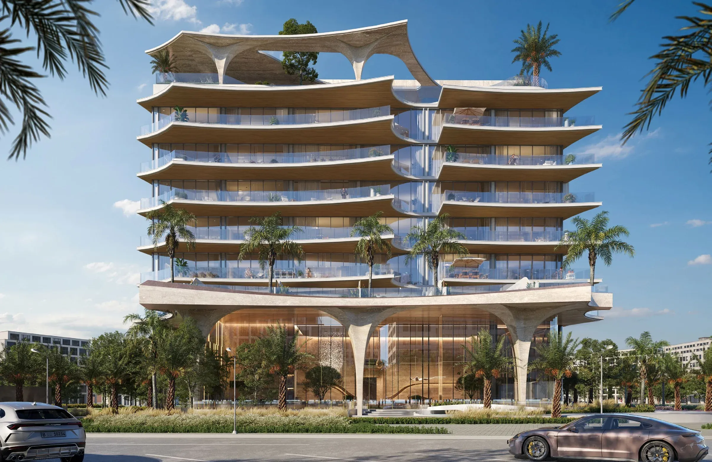 Front exterior of Ola Residences with curved balconies and a landscaped arrival area on Al Marjan Island