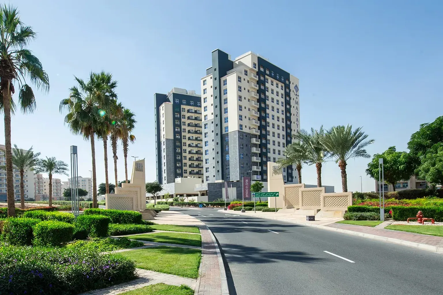 Landscaped residential streets and apartment buildings in Liwan, Dubai