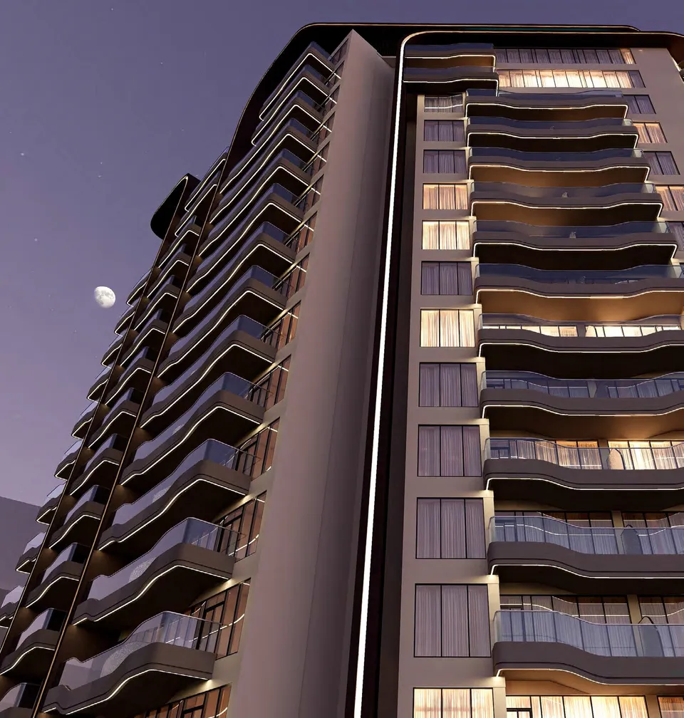 Reef 995 tower facade with illuminated residences and curved balcony lines by REEF Luxury Developments