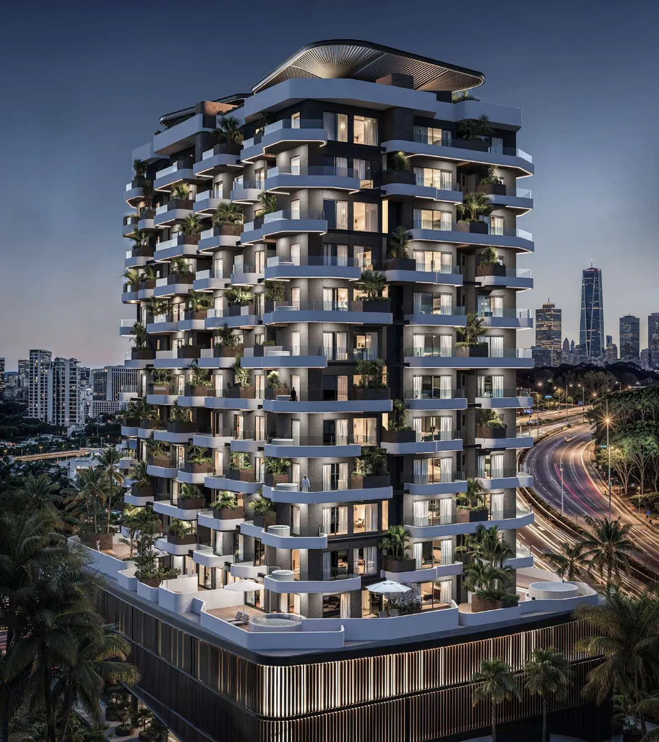 Marea Residence exterior at twilight with illuminated balconies by Sharafi Development