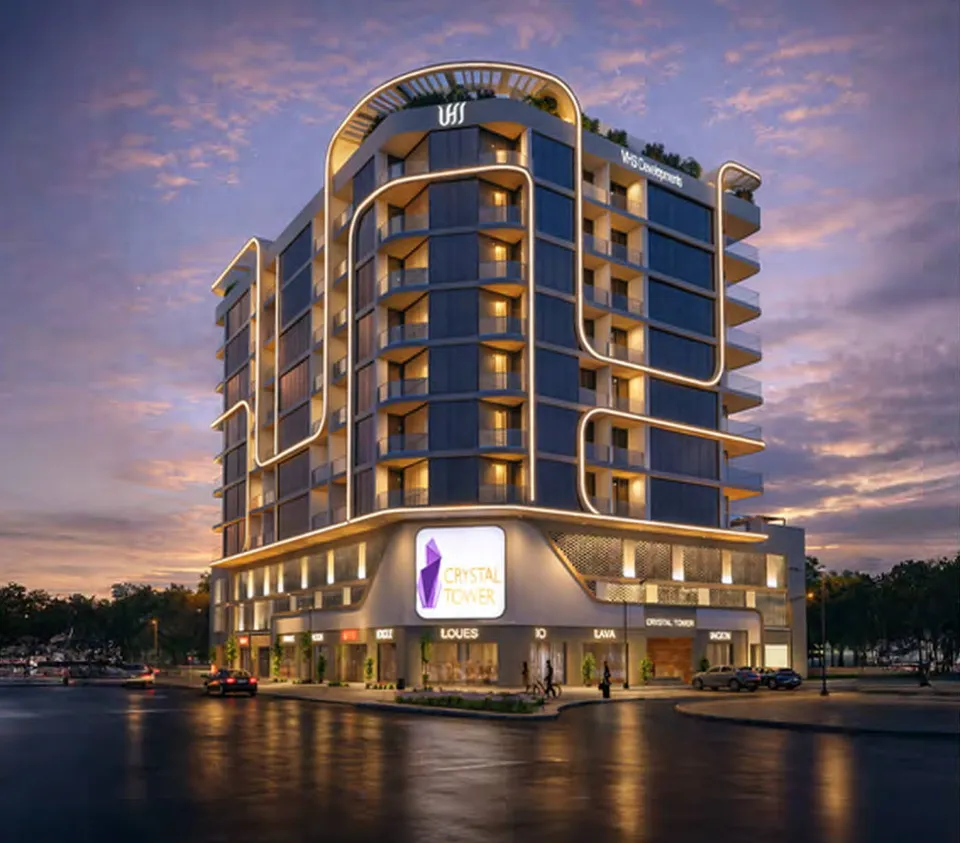 Crystal Tower exterior with curved balconies and illuminated ground-floor frontage by VHS Developments